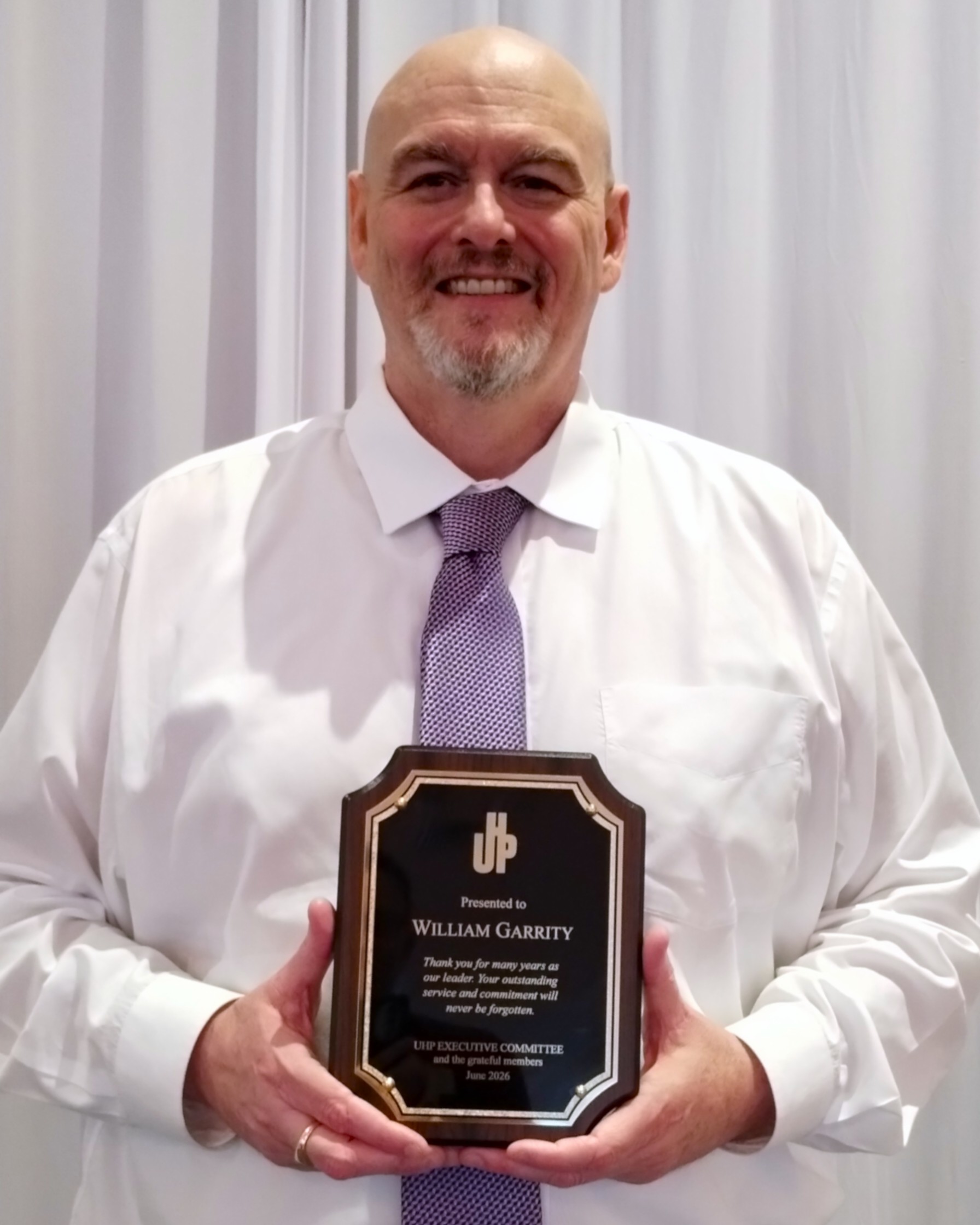 Bill with his special plaque from the executive committee and membership