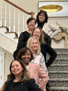 group portrait of members on lobby staircase