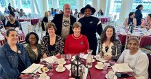 group portrait of members at table