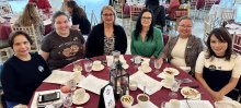 group portrait of members at table