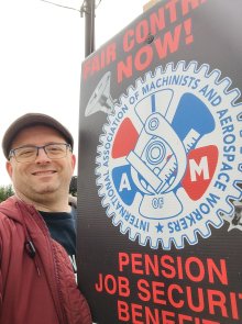 DeFran with picket sigh "Fair contract now, pension, job security, benefits, IAM"