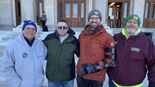 group portrait of four outside state Capitol