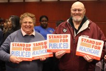 Dawn and Bill at Capitol holding Stand Up signs