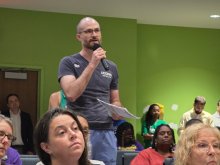 Paul Banach standing to speak during a forum